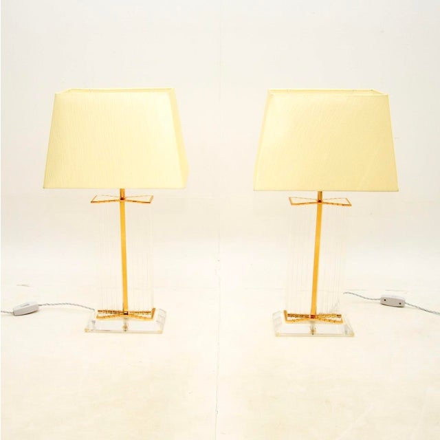 A large and impressive pair of vintage French acrylic glass and brass table lamps. They were recently imported from...
