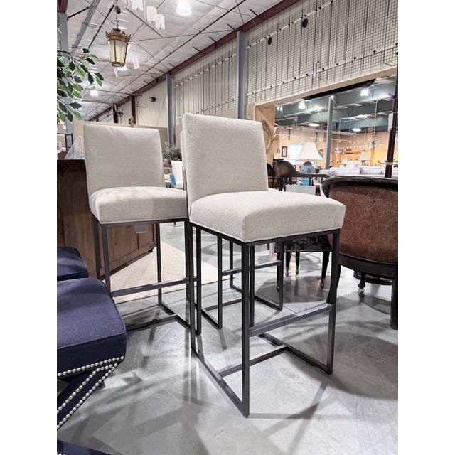 A refined set of three Gage counter stools by Mitchell Gold + Bob Williams, featuring clean architectural lines and a...