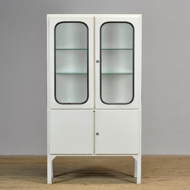 Vintage medical cabinet from the 1970s, manufactured in Hungary. This characterful cabinet is constructed from iron and...