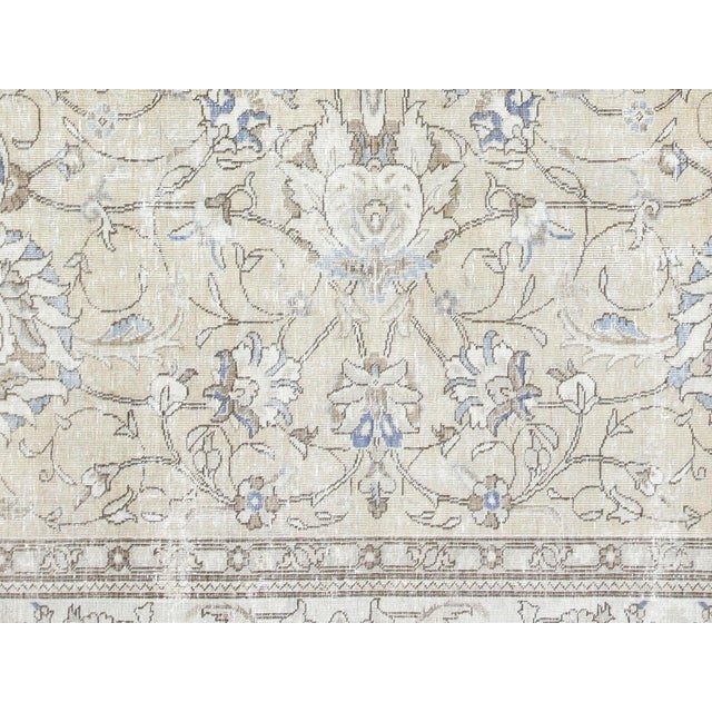 This lavish hand-knotted Persian Tabriz rug adds the perfect touch of elegance to any space. Its intricate design features...