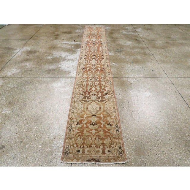 An antique Persian Malayer rug in runner format handmade during the early 20th century. Measures: 2' 0" x 14' 6" Persian...