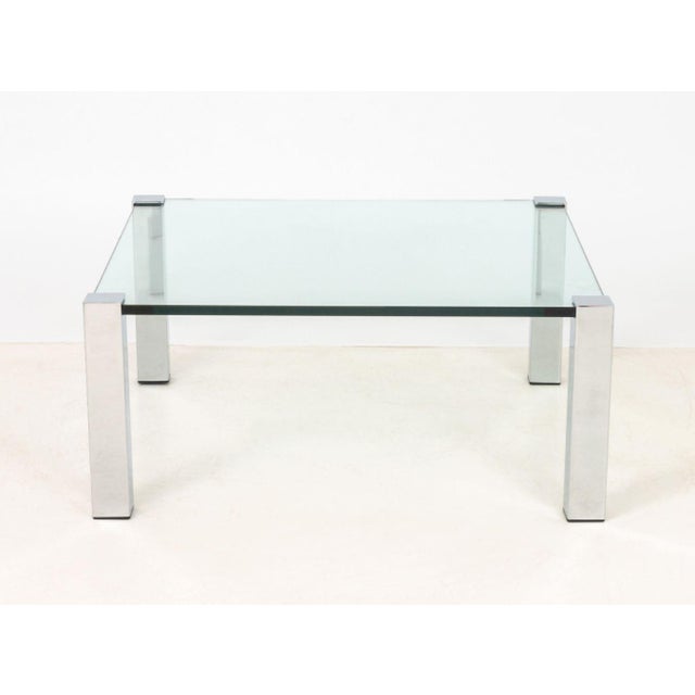 Italian Chrome and Glass Top Coffee Table. 16.25" H x 37.5" W x 37.25" D. Provenance: From the Estate of Gerard Stora,...