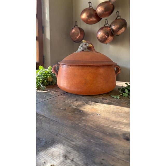 A sculptural mid-century French ceramic poultry roaster imported by Lamalle N.Y.C., bearing the retailer’s Eiffel Tower...