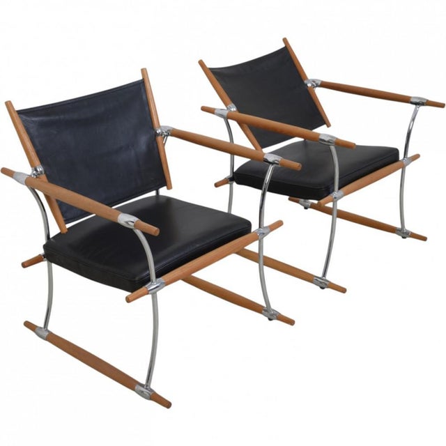 Set of two Stokke chairs, designed by Jens Quistgaard and manufactured by Nissen Langaa. The chairs are upholstered in...