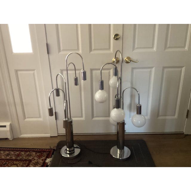 These eye-catching table lamps combine shiny chrome surfaces with oversized round white bulbs. The table lamps feature...
