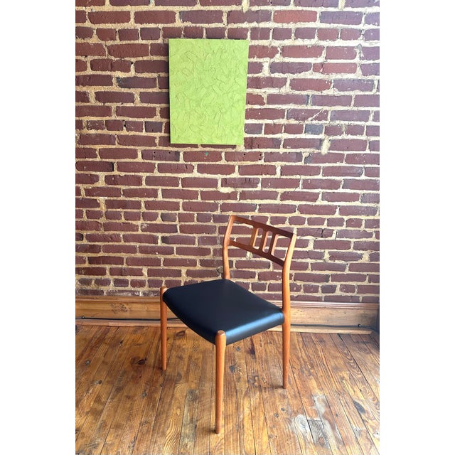 Item: J.L. Mollers Model 79 Dining Chair Designer: Niels Moller Period: 1960s Materials: Teak, Vinyl Listing is for a...