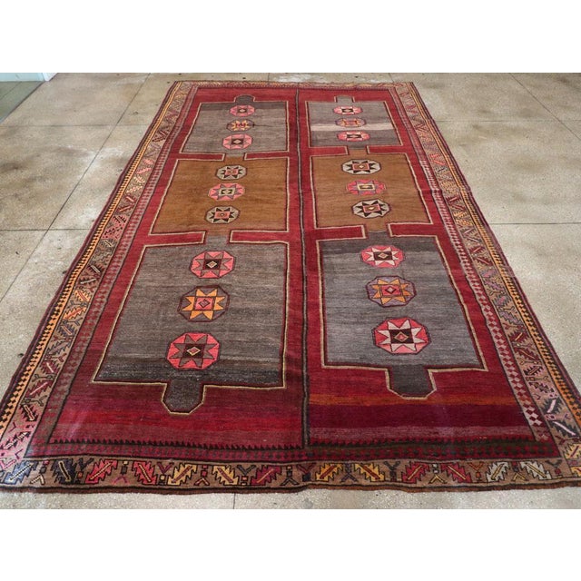 A vintage Turkish Anatolian tribal room size carpet handmade during the mid-20th century. Measures: 9' 1" x 15' 3".