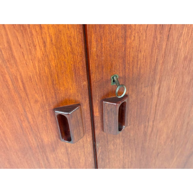 Small Danish teak cabinet with two doors, designed by B. Mogensen for Søborg Møbelfabrik. The doors feature beautiful...