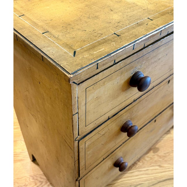 A beautifully timeworn early 19th-century English country chest of drawers, dating to approximately 1800–1820. This four-...