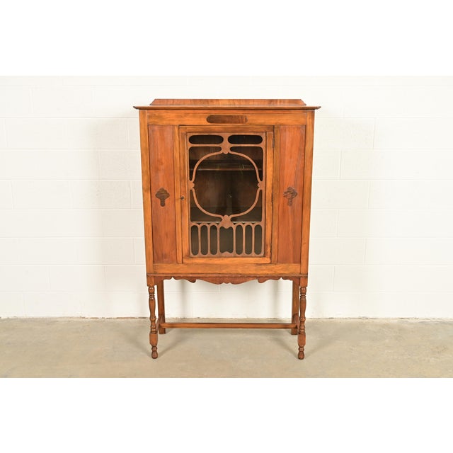 A gorgeous English Jacobean or Art Nouveau style bookcase, china hutch, or bar cabinet In the manner of Berkey & Gay USA,...