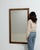 A 20th century French wall mirror presented within a substantial wooden frame. The rectangular form is defined by clean...