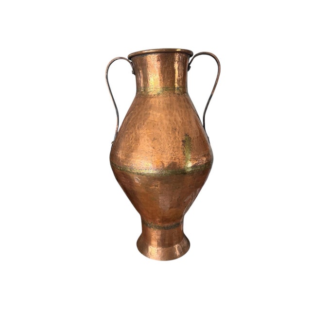 Beautiful large hammered copper vessel. In various places on the container (around the center of the jug at its widest...