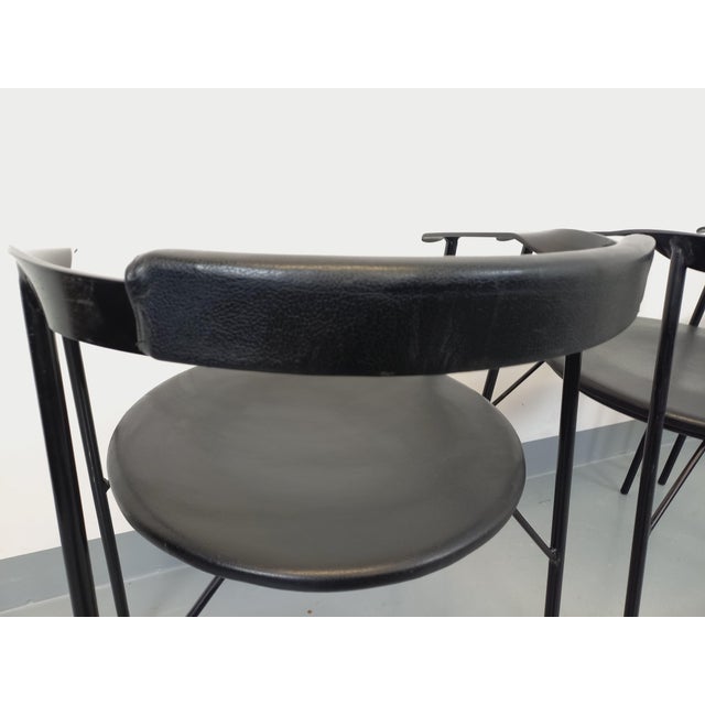 Four vintage armchairs from the 1980s, in black metal and black vinyl, with round seats, minimalist Italian design, sleek...