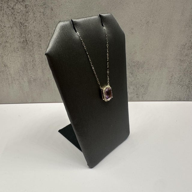 This elegant amethyst and diamond necklace in 10kt yellow gold features a beautifully cut emerald cut amethyst measuring...