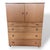 A classic mid-century tallboy cabinet by Schreiber, featuring a beautifully grained teak finish with contrasting darker...