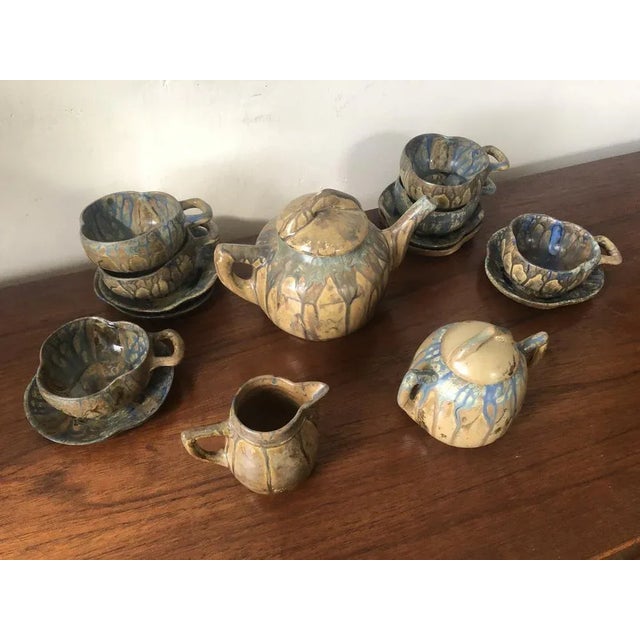 Exceptional handmade and signed tea service with a blue running glaze in very good condition.