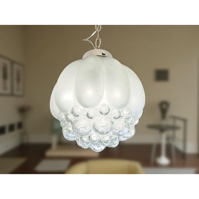 Amazing bubble glass hanging lamp, from the 1960s. The aluminium support is fully restored and newly chromed. New...