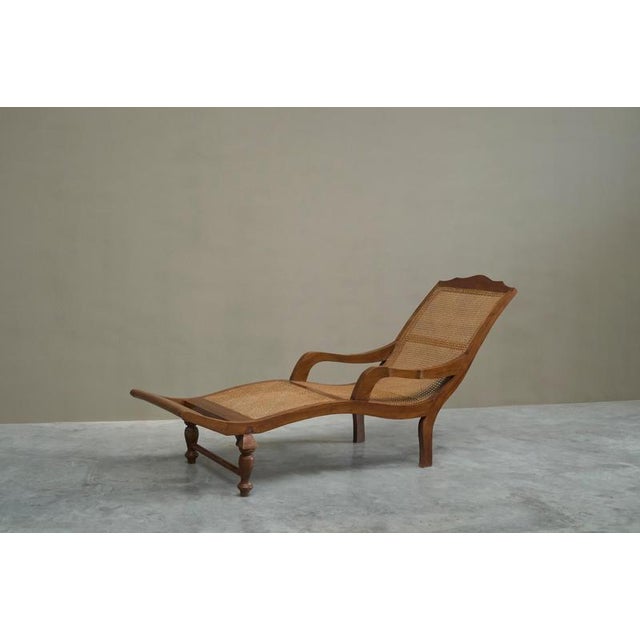 Sculptural Colonial Chaise Longue in Wood and Hand Woven Cane Webbing Early 20th Century An elegant Dutch Colonial chaise...