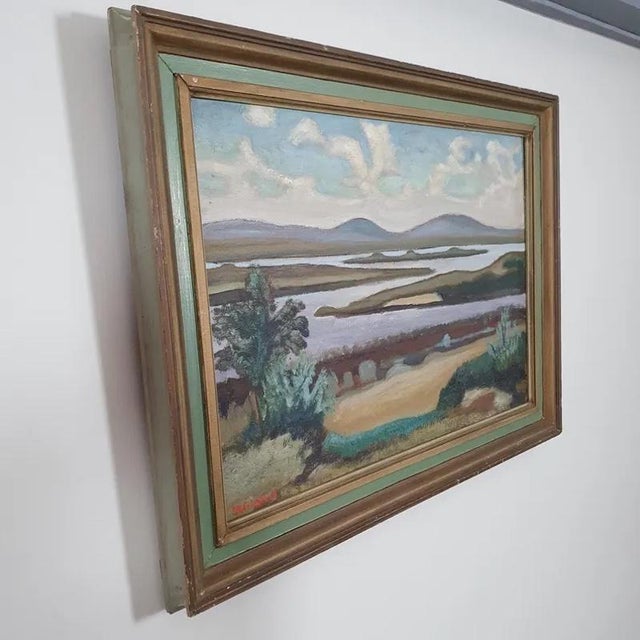 A beautiful vintage swedish landscape painting depicting a lake area with rolling hills in the background. Painted in oil...