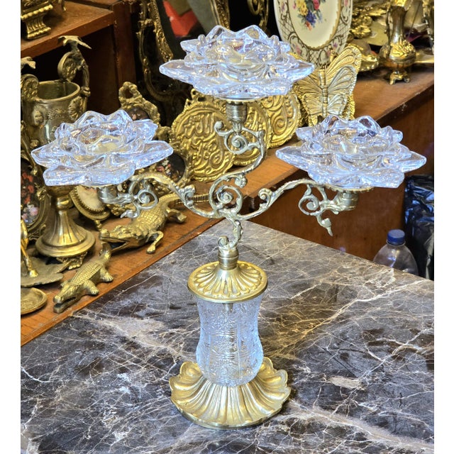 This ornate brass and crystal decorative holder is designed to hold up to three candles, creating a balanced and elegant...