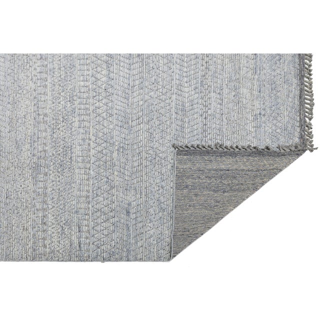 Elevate your space with this Modern Moroccan Style Wool Rug, featuring a sophisticated blend of muted blue, slate grey,...