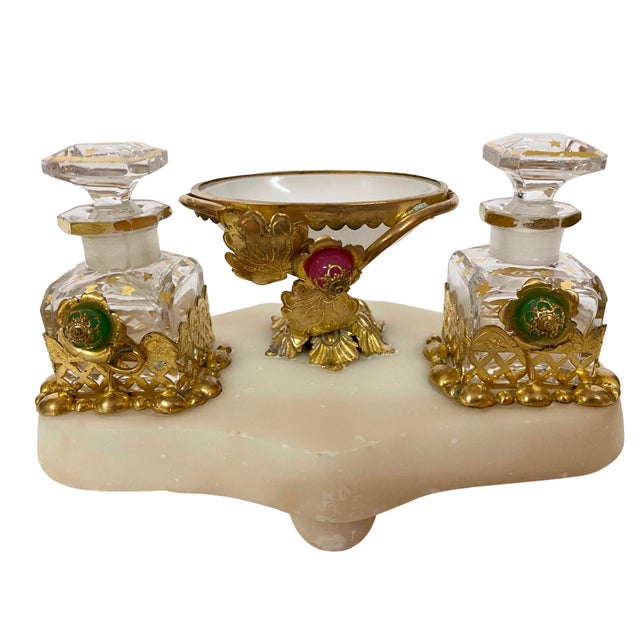 A Napoleon III Palais Royal style perfume stand with a marble base flaked with a pair of gilt decorated perfume bottles....