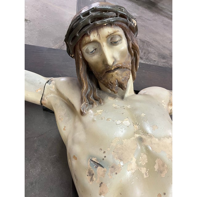 This antique life-size figure of Christ on the cross originated from the Slavic Village Neighborhood congregation in...
