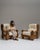 This pair of 1970s Brutalist oak upholstered armchairs from France, made in chunky carved oak with cream cushions. The...
