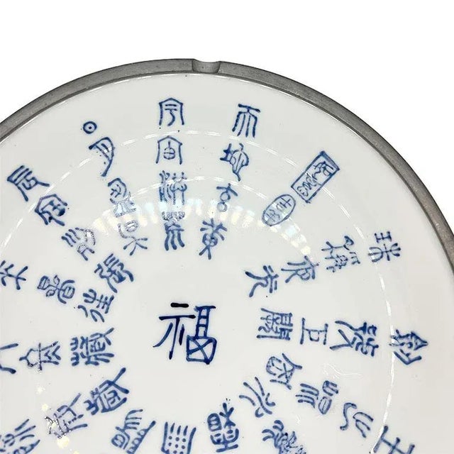 A large round vintage ceramic and pewter chinoiserie bowl. This large ceramic bowl is created from crisp white ceramic. It...