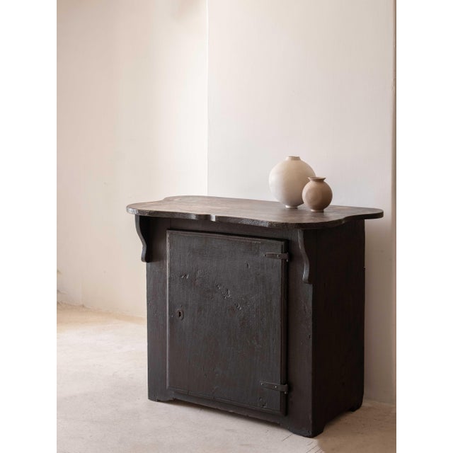 Small, dark, single-door sideboard with original dark patina. One shelf inside. Recovered in Spain, early 19th century.
