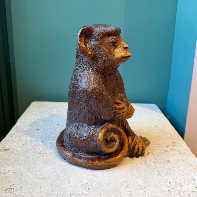A wonderfully charming carved resin monkey statue. C.1970's. Dimensions: 5.75"W x 7.5"D x 10"H
