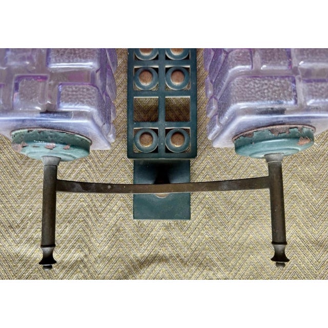 A striking and unusual Art Deco modernist wall sconce showcasing bold geometric design and luxurious materials. The frame...