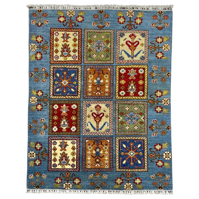 A blue field surrounds twelve garden panels, each filled with a distinct floral motif. Cream, rust, sage green, and deep...