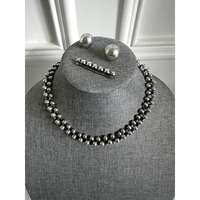 A rare four-piece suite of Mexican Modern silver jewelry suite circa 1940s from Taxco, Mexico and crafted by William...