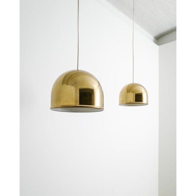 A rare and decorative pair of swedish mid century ceiling pendant lamps in patinated brass by eje ahlgren for bergboms...