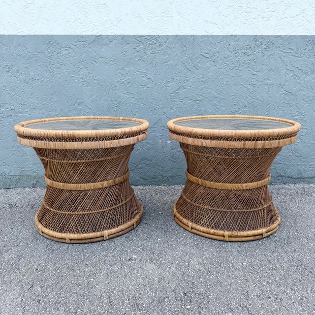 A striking pair of Boho Chic side tables crafted from buri rattan with sculptural hourglass silhouettes and intricate...