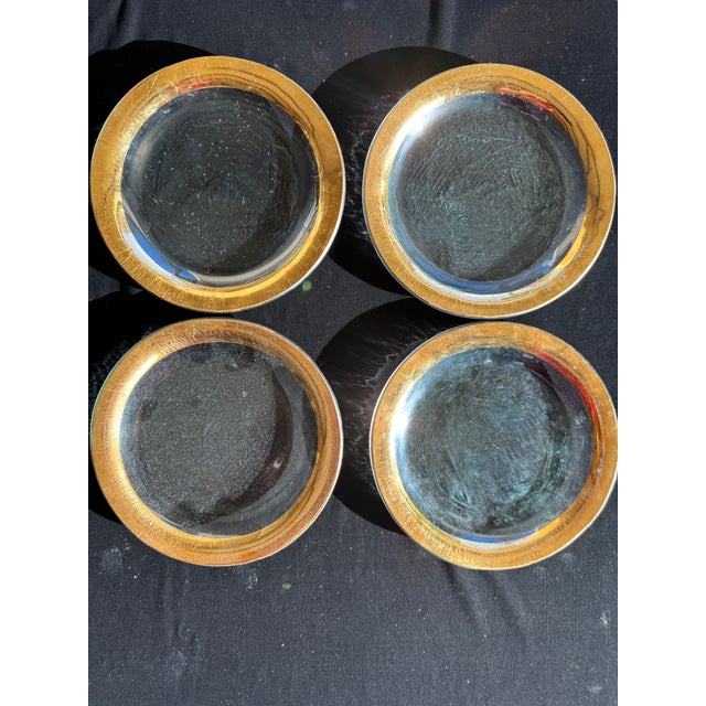 A set of four Annieglass “Roman Antique” appetizer plates, each hand-formed glass with a 24k gold rim. Most examples are...