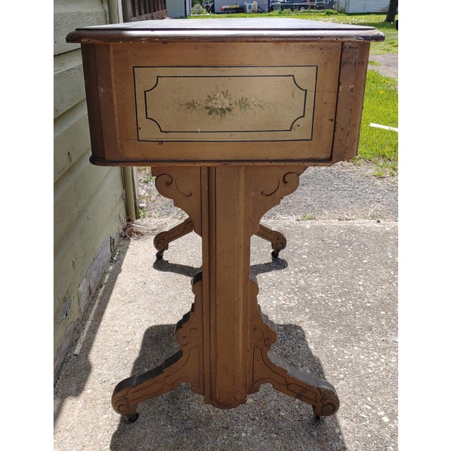 Here's a very cool and unusual sewing table circa 1860s-1880s. This is walnut and was hand painted in the Cottage style,...