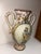 Hand-painted majolica ceramic vase with handles depicting Saint Joseph with the Baby Jesus and featuring delicate floral...