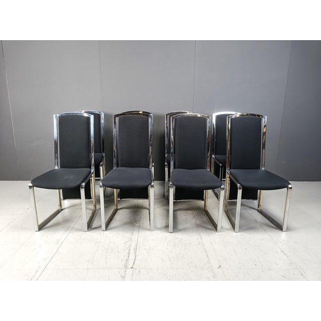 Vintage dining chairs made from brass and chrome with black fabric upholstery. Timeless design chairs from the seventies....