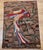Vintage American hand hooked pictorial rug in a wonderful depiction of a parrot on a tree branch. The rug has a delightful...