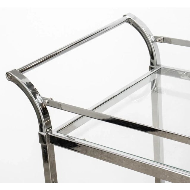 Modern Chrome & Glass Two-Tiered Bar Cart, on four caster wheels.