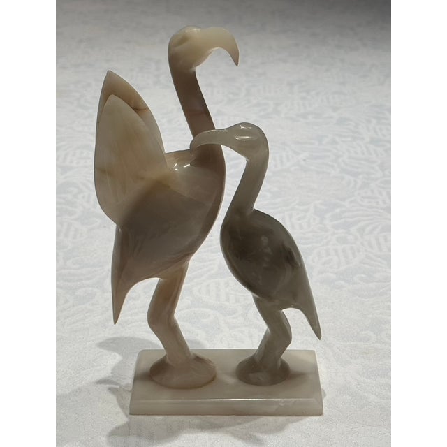An exceptional late-20th-century modernist stone sculpture depicting a stylized pair of wading birds, meticulously hand-...