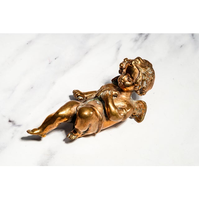 This charming solid metal cherub putti sculpture is a beautifully modeled decorative piece with wonderful weight,...