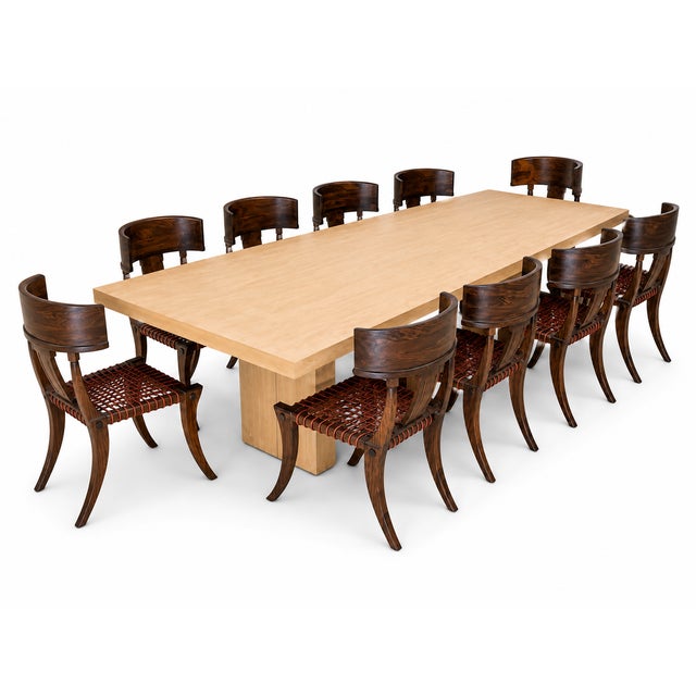 Klismos solid walnut dining chairs. The chairs are made of solid walnut with a satin finish and leather cording. The...