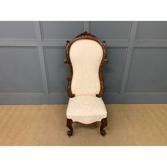 A charming mid Victorian period rosewood high back chair. Very well constructed in solid rosewood and adorned with crisply...