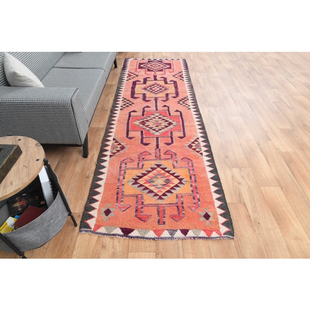 Vintage Hand-Knotted runner rug is a semi-antique vintage area rug. The '70s Eastern region of Anatolia's unique rug is...
