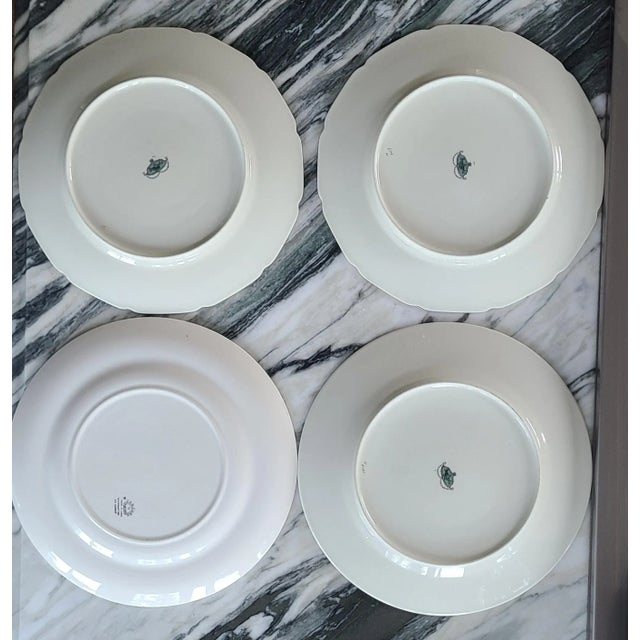 Here is a set of 4 vintage mix-and-match garden party style dinner plates. Each with a broad, colorful decorative band and...