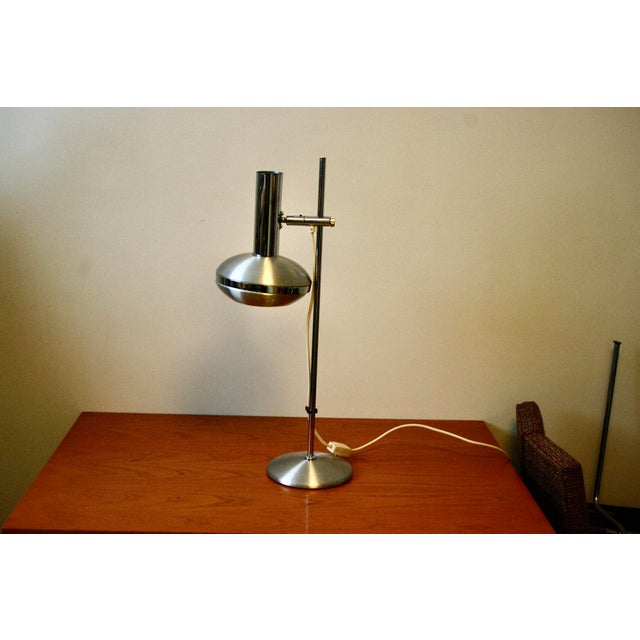 Brushed aluminum desk lamp, space age relabel, adjustable height and head rotation, in good condition This piece is...