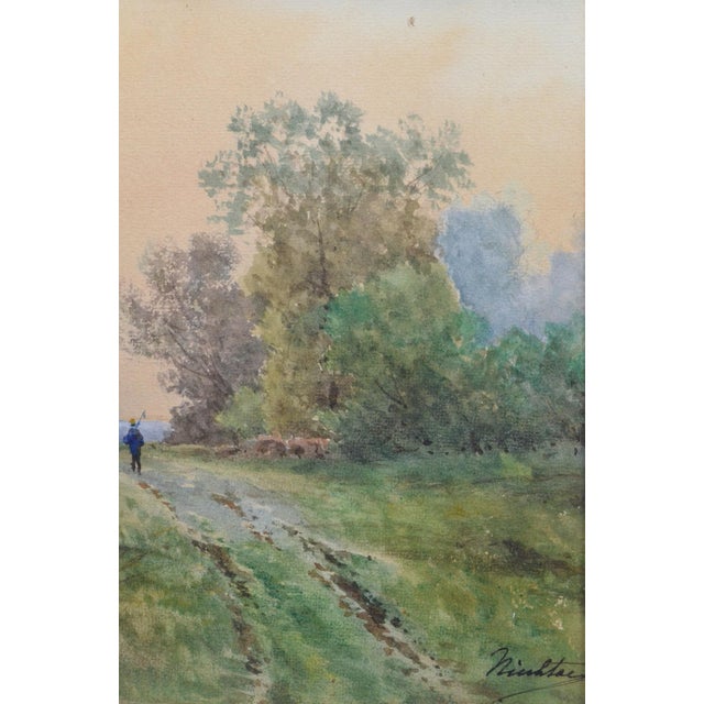 Charming antique French watercolor depicting a solitary figure walking along a country path through a softly wooded...